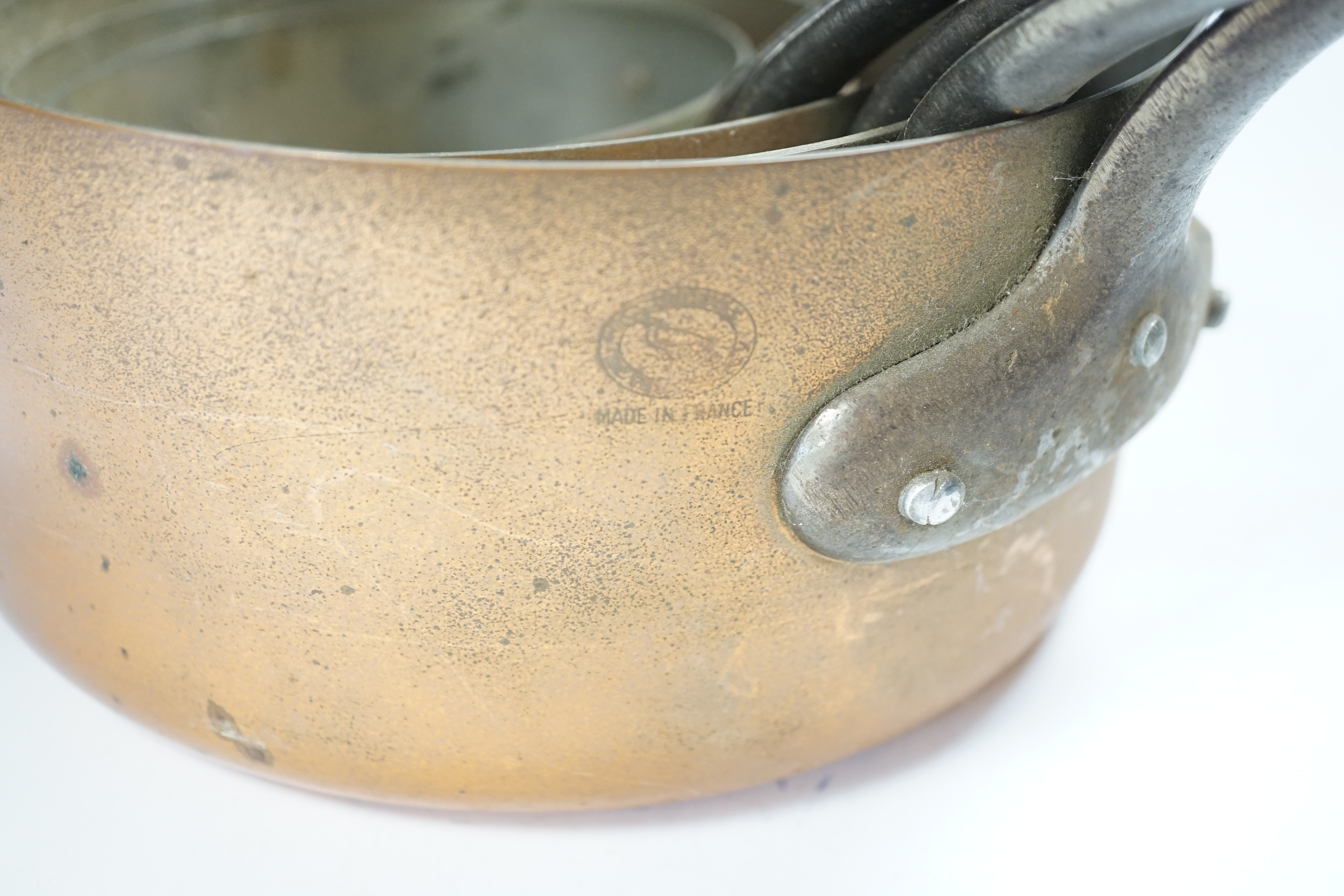 A set of five French graduated copper saucepans, signed Faucogney